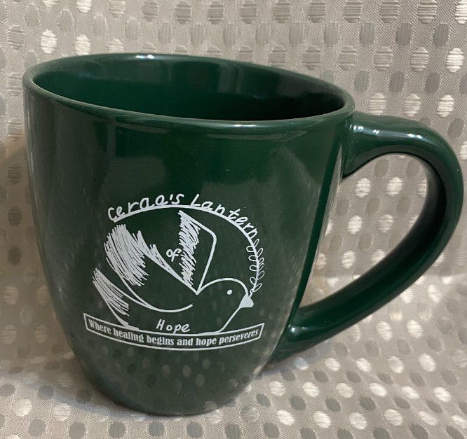 A green coffee mug with the words " cedar rapids, ia."